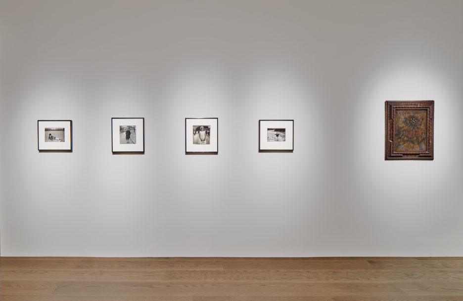installation view with a row of Diane Arbus photographs