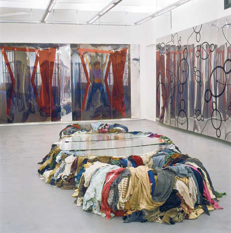 Clothes piled forming Michelangelo Pistoletto Third Paradise symbol at Cittadellarte