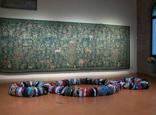 Clothes laid out in Michelangelo Pistoletto Third Paradise symbol, Rebirth day, Pistoia Galleria Vannucci