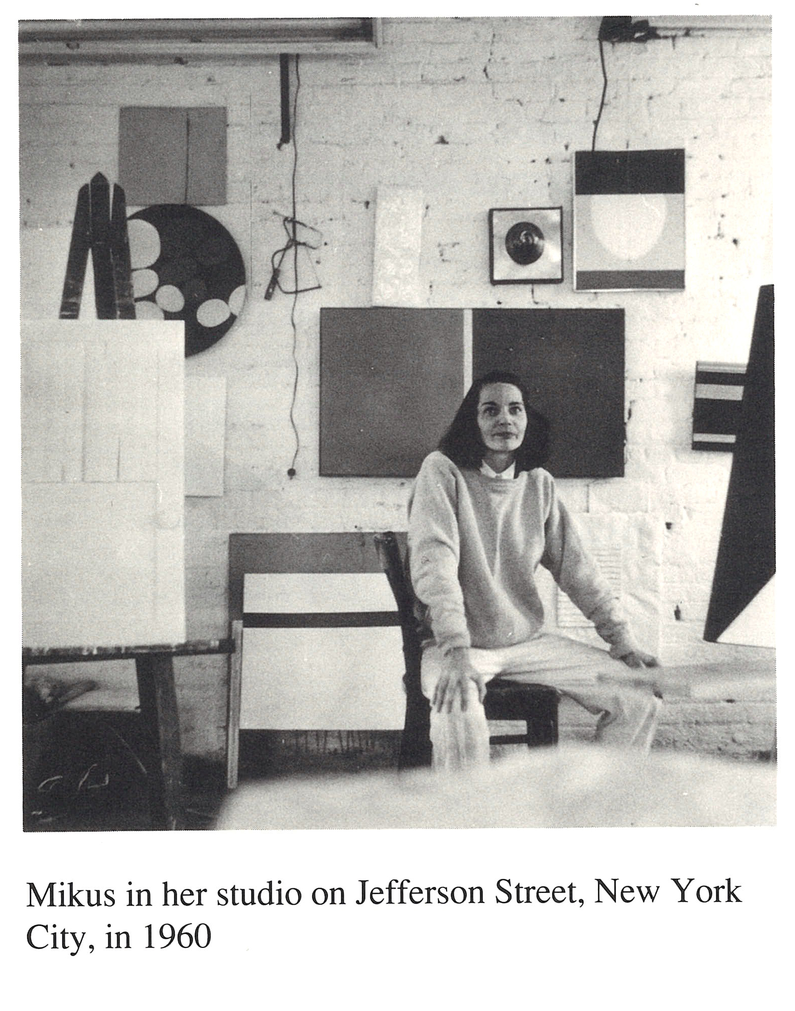 Archival image of Eleanor Mikus sitting amongst her works in her Jefferson Street studio