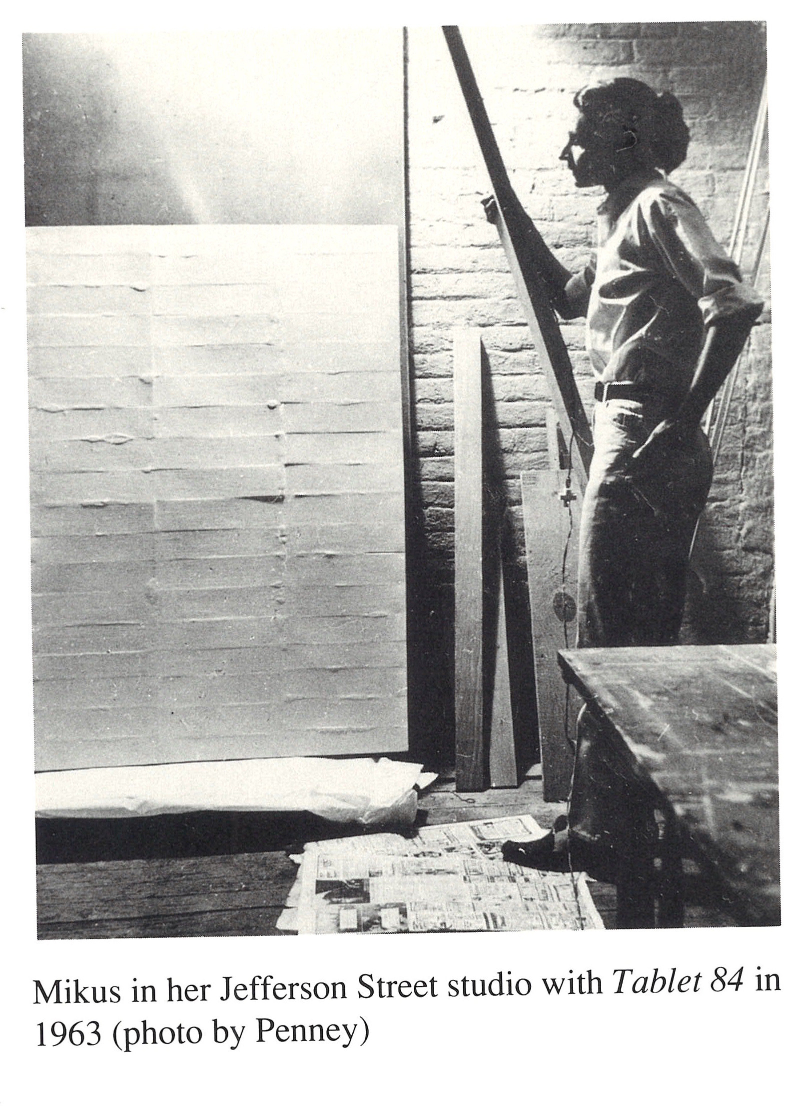 Archival image of Eleanor Mikus in her Jefferson Street studio with her work Tablet 84